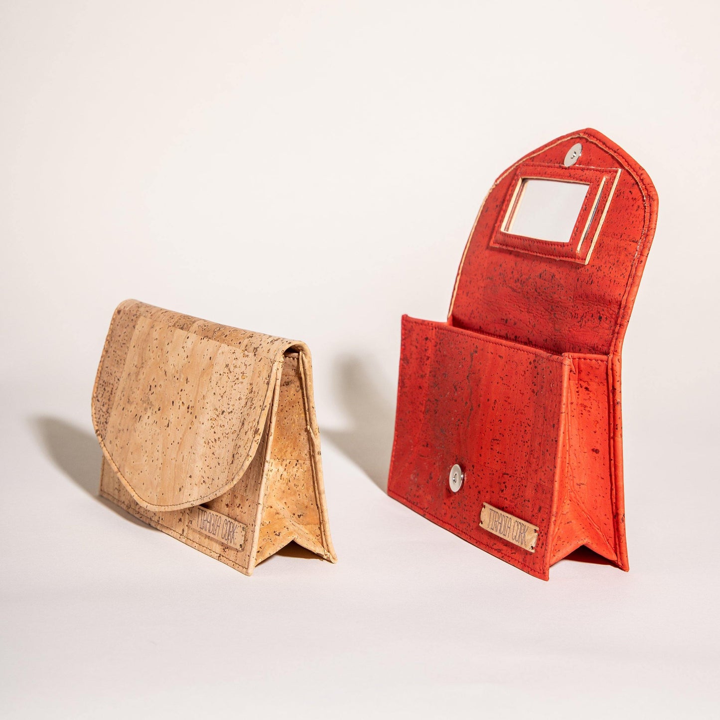 a red piece of luggage sitting on top of a white surface