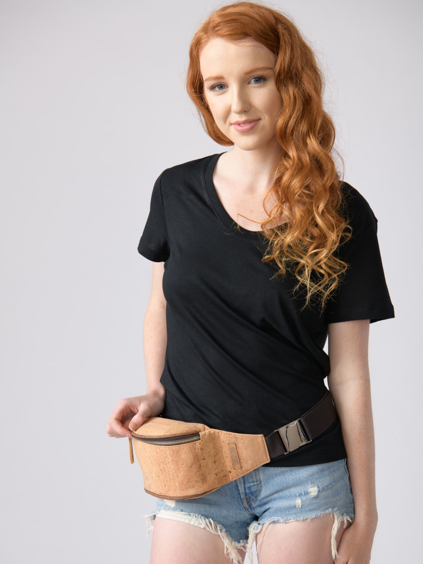 a woman in a short skirt standing next to a wall